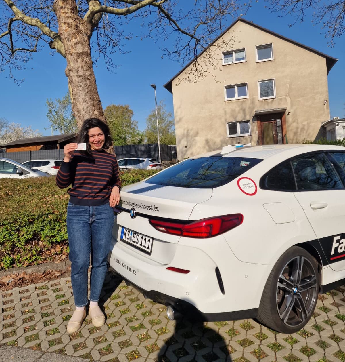 Mina mit ihrem Führerschein vor dem Fahrschulzentrum Kassel